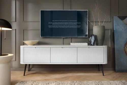 Biała szafka RTV Luna z drzwiczkami i ryflowanymi frontami z czarnymi nogami
