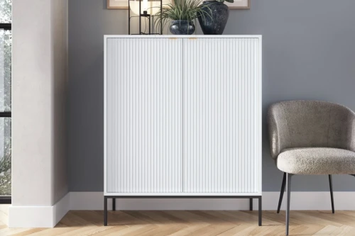 Komoda wysoka Nuo biała z ryflowanymi drzwiami